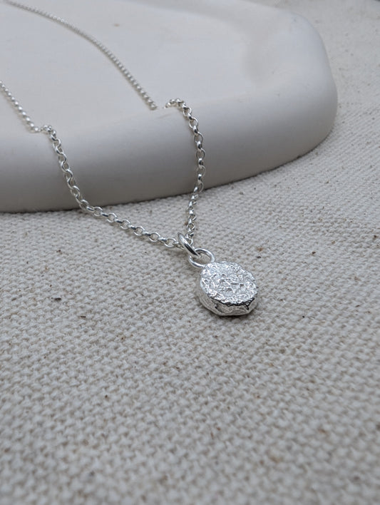 Sandcast disc necklace