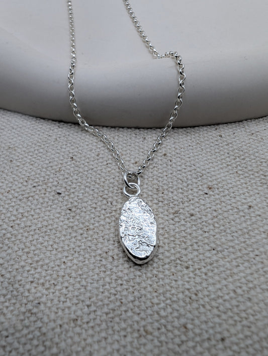 Sandcast silver oval pendant